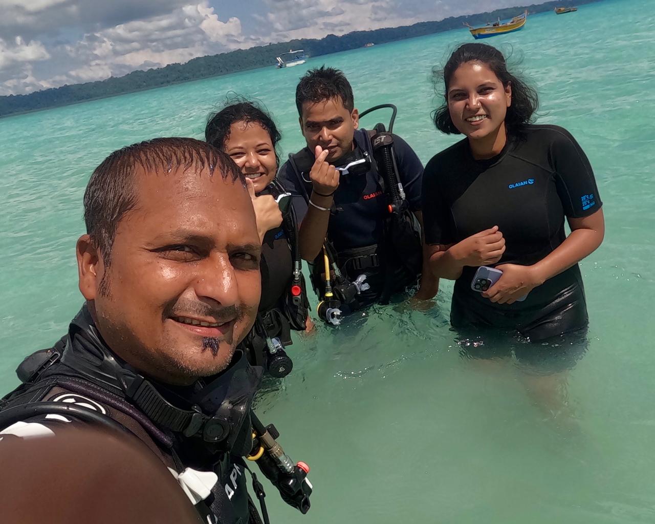 Paritosh helping a beginner scuba diver underwater